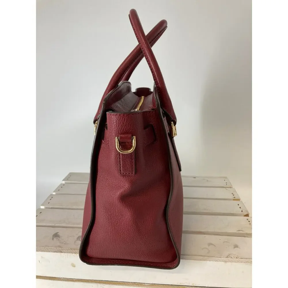MICHAEL KORS, LARGE WINE LEATHER HANDBAG WITH LOCK CHARM.